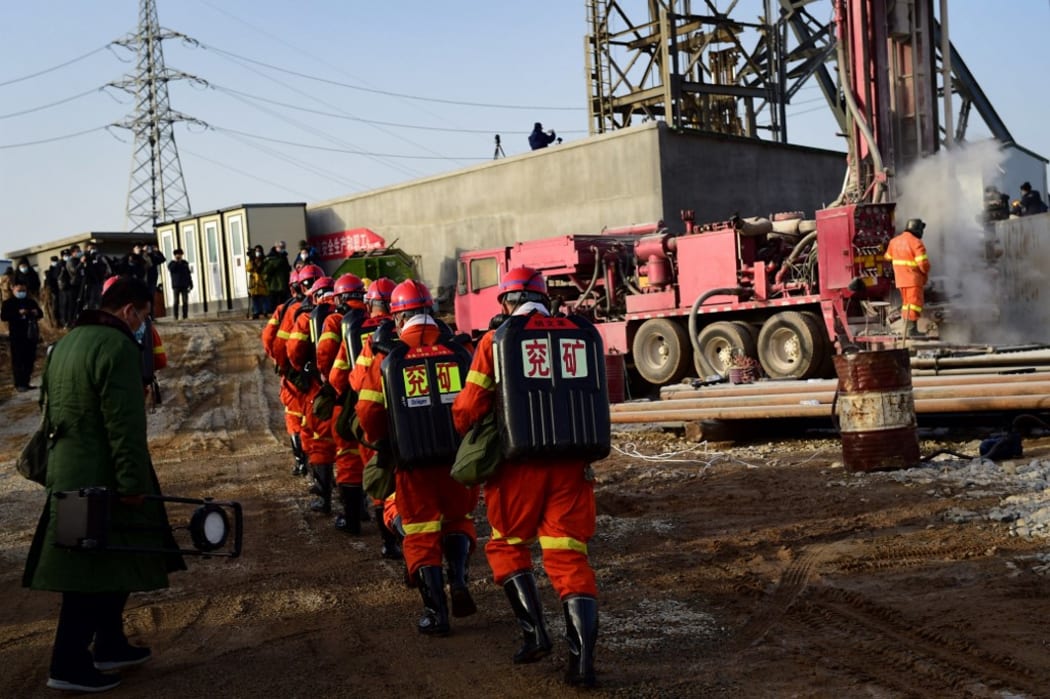 This photo taken on January 13, 2021 shows rescuers working at the site of gold mine explosion where 22 miners were trapped underground in Qixia, in eastern China's Shandong province.
