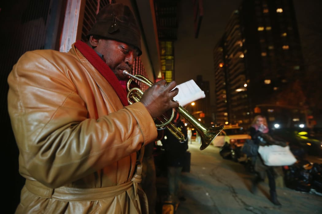 Benjamin Norris Scott plays music on Avenue C in Lower Manhattan's East Village a few hours after power was restored to the neighborhood.