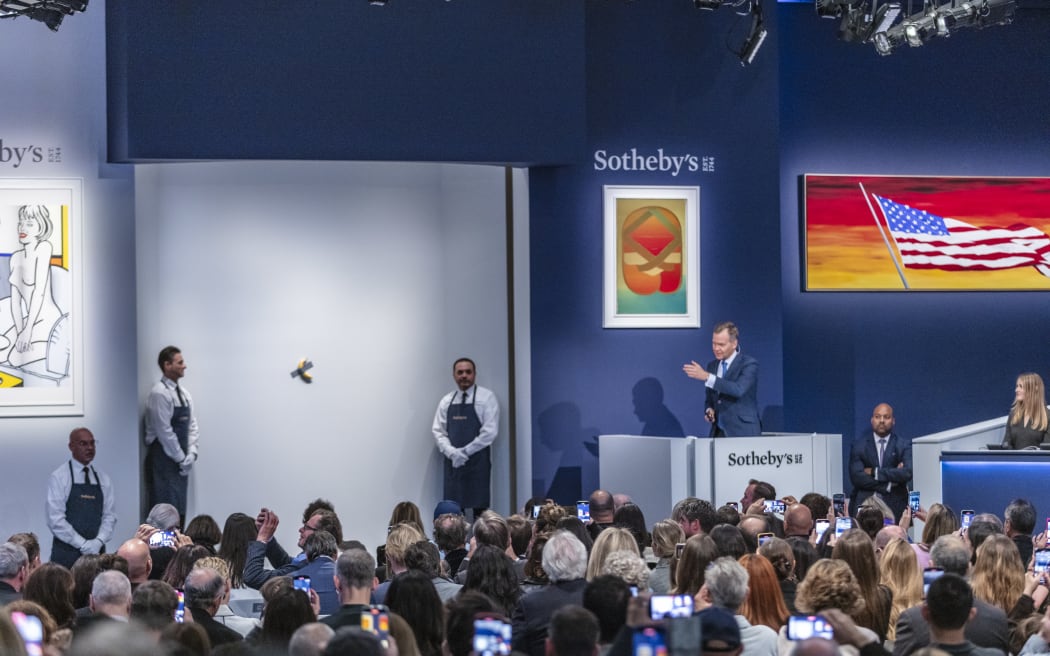 Seven bidders competed to seize Italian artist Maurizio Cattelan's latest edition of his 'Comedian' artwork on 20 November in New York.