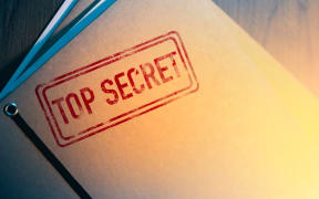 Private investigator desk with top secret envelopes