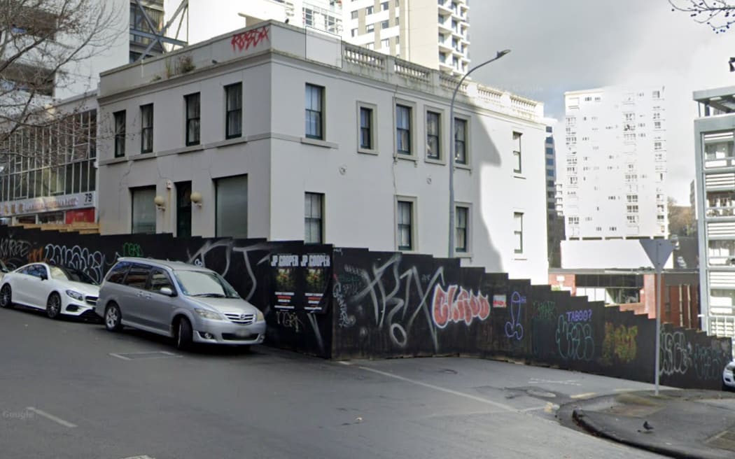 The former Fitzroy Hotel on the corner of Wakefield and Lyndock streets in Auckland CBD in July 2024. Half of Lyndock Street was boarded up but recently workers came back and totally blocked off Lyndock Street with hoardings.