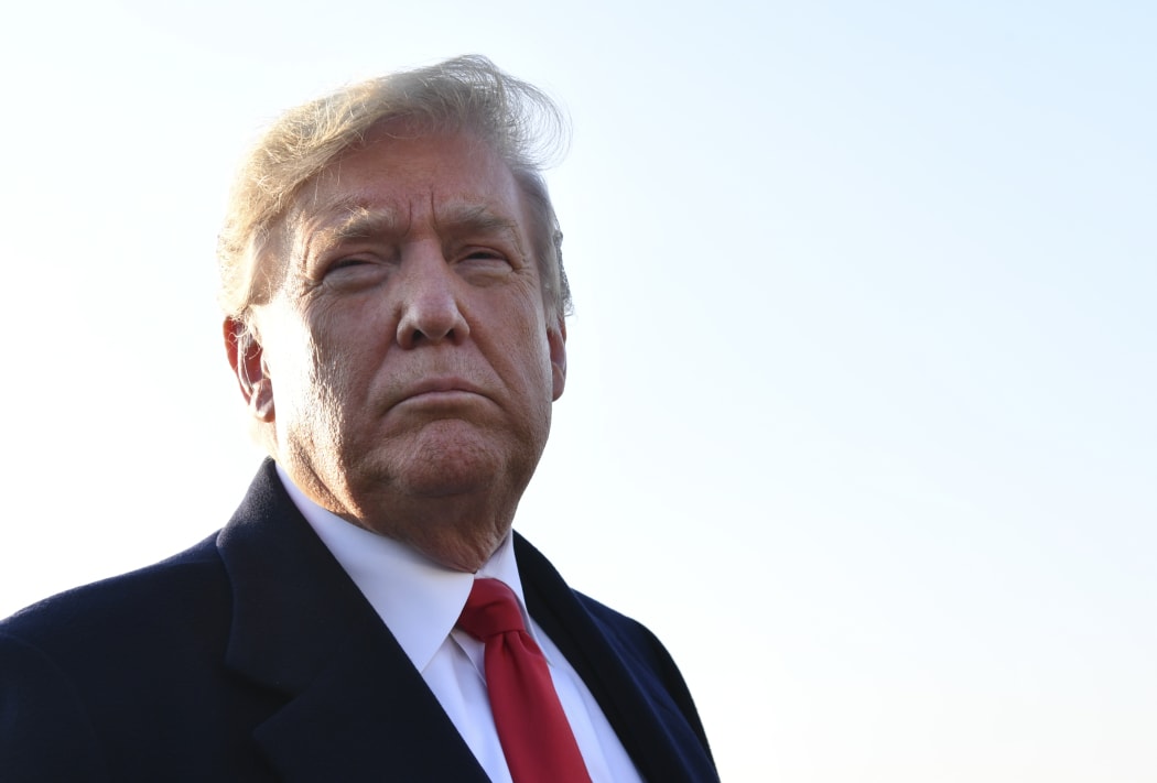 US President Donald Trump speaks with reporters.