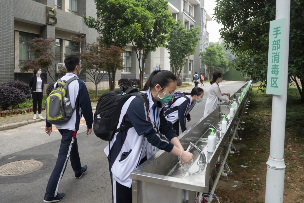 Senior students wash hands after entering school at Hubei Wuchang Experimental High School in Wuhan, central China's Hubei Province, May 6, 2020.