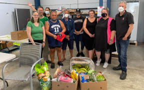 Co-op members all gather once a week to pack the food boxes together in a warehouse next to the Clendon family store.