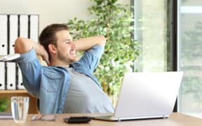 Worker looking outside office window, thinking. (File photo)