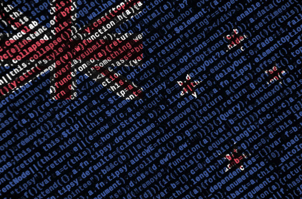 New Zealand flag  is depicted on the screen with the program code. The concept of modern technology and site development.