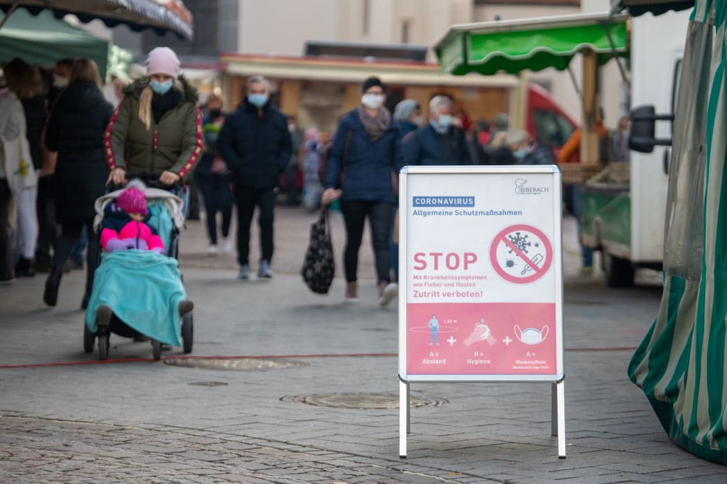 A sign showing Covid-19 measures at the weekly market in the district of Biberach, southern Germany.