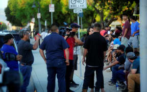 Residents gather at the Gilroy High School after mass shooting at the Garlic Festival in Gilroy, California.