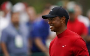 Tiger Woods smiles as he walks off the seventh tee during the final round for the Masters golf tournament, Sunday, April 14, 2019, in Augusta, Ga.