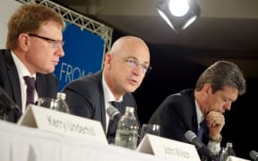 Fonterra chief executive Theo Spierings announces a large profit fall with chairman John Wilson, left, and chief financial officer Lukas Paravicini, right.
