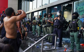 ATLANTA, GA - MAY 29: Police officers guard CNN Center during a protest on May 29, 2020 in Atlanta, Georgia. Demonstrations are being held across the U.S. after George Floyd died in police custody on May 25th in Minneapolis, Minnesota.