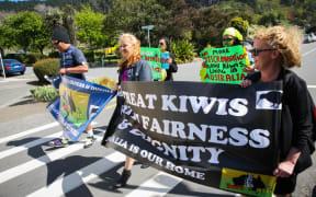 Erina Morunga and protesters march from the Australian High Commission