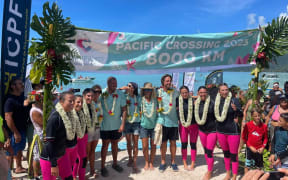 The women, on the left and right, are welcomed at Moorea.