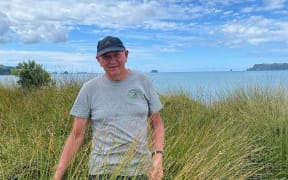 Kim Lawry stands among spinifex.