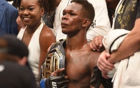 Israel Adesanya reacts after winning the UFC interim MW title belt a bout against Kelvin Gastelum.