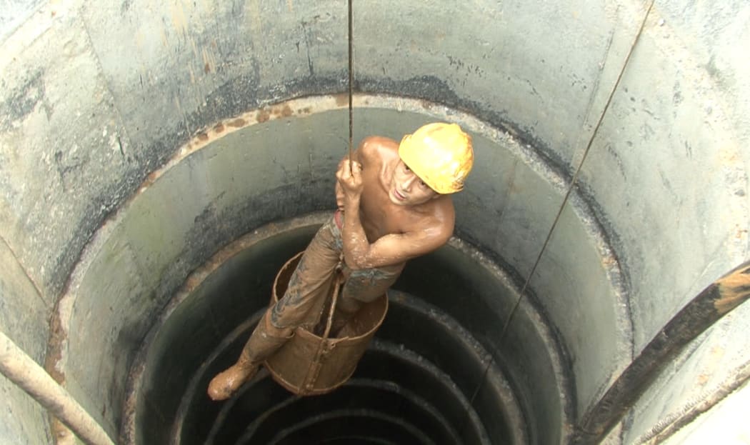 A migrant worker digs highway foundations by hand in Zhang Zanbo’s documentary The Road
