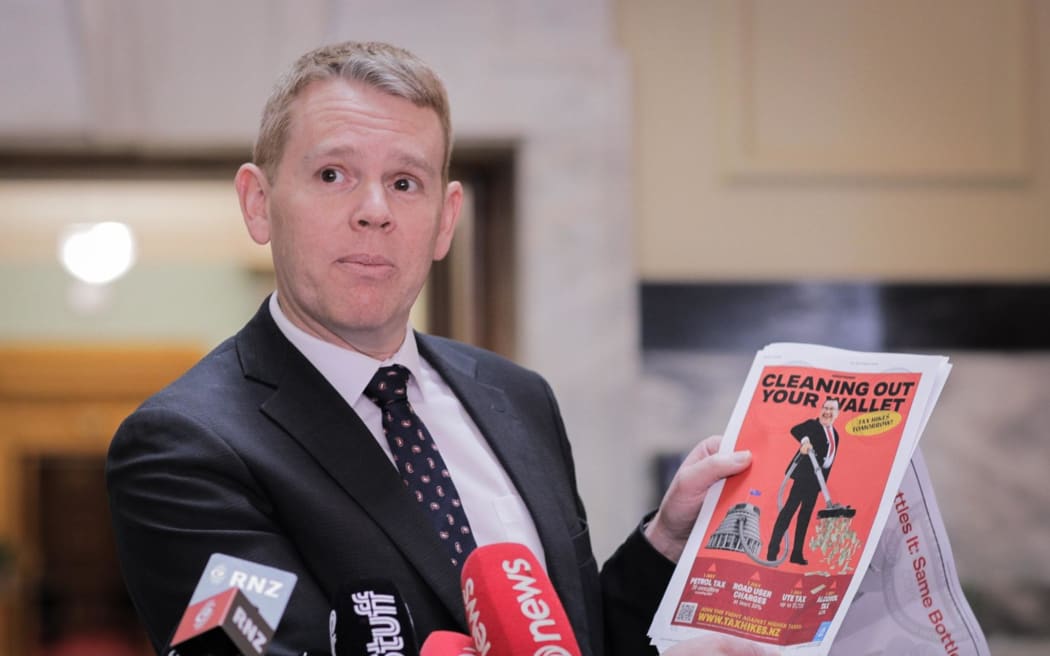 Labour Leader Chris Hipkins holds up a series of attacks ads which mention him or other Labour MPs. He says they have been shared by National and/or its MPs.