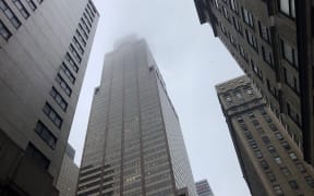 Mist and smoke cover the top of a building near 51st Street and 7th Avenue where a helicopter was reported to have crash landed on top of the roof of a building in midtown Manhattan.