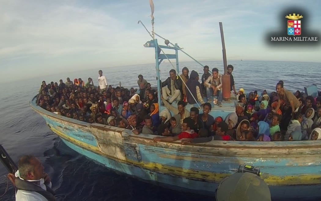 Thousands of migrants were rescued in the Mediterranean by the Italian coast guard over the weekend. This boat was spotted near Lampedusa on 3 May.