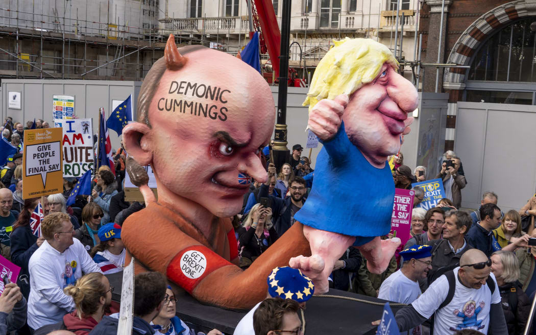 Demonstrators march with an effigy depicting Britain's Prime Minister Boris Johnson as a puppet operated by his advisor Dominic Cummings during a rally by the People's Vote organisation in central London on October 19, 2019,