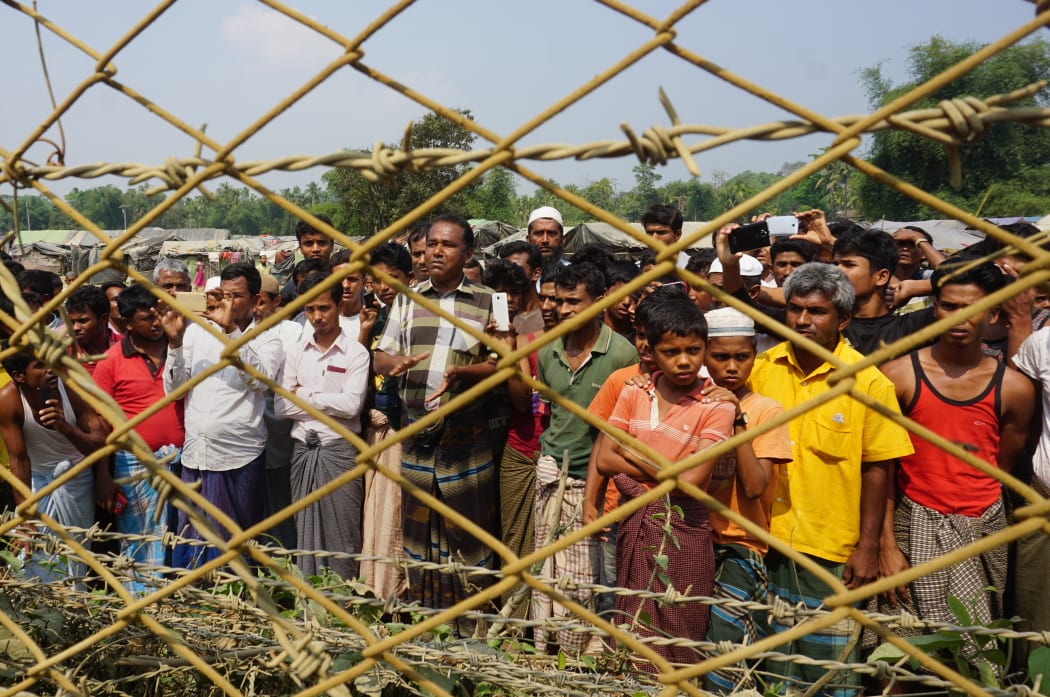 Rohingya Muslims gather behind Myanmar's border lined with barbed wire fences in Maungdaw district, located in Rakhine State bounded by Bangladesh.