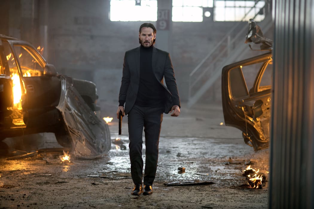 Keanu Reeves as John Wick, looking for vengeance but wanting to retire.