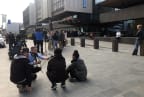 RNZ senior producer Justin Gregory (kneeling, with microphone) talks to locals in front of the Justice Precinct in Christchurch.