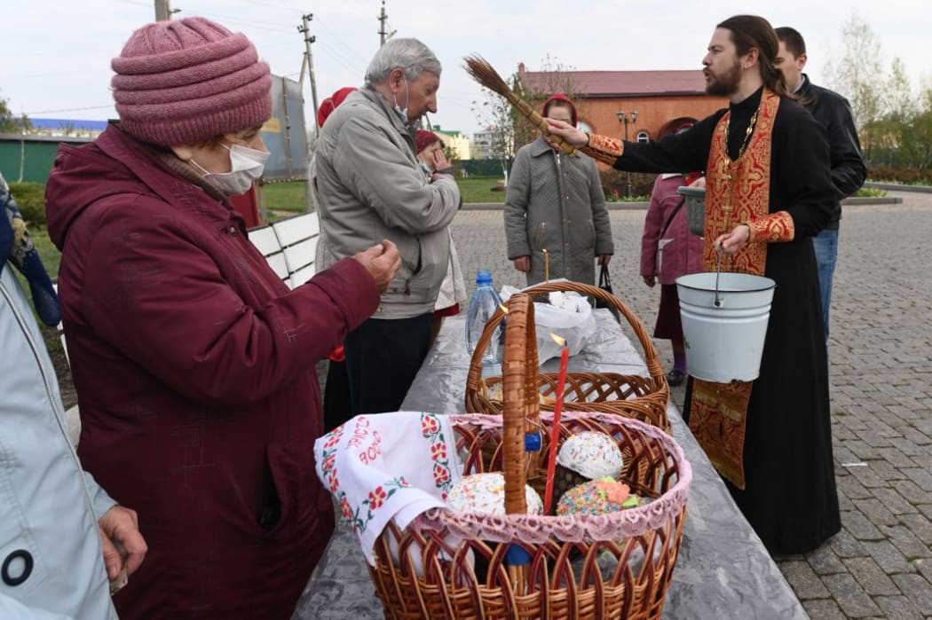 An orthodox priest blesses Easter cakes and eggs with holy water during Easter celebrations at Krasnodar region, Russia.  Sergey Pivovarov / Sputnik
