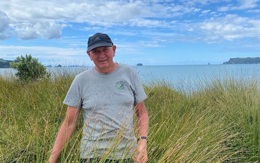 Kim Lawry stands among spinifex.