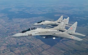 Two MiG 29 fighter jets take part in the NATO Air Shielding exercise near the air base in Lask, central Poland on October 12, 2022.