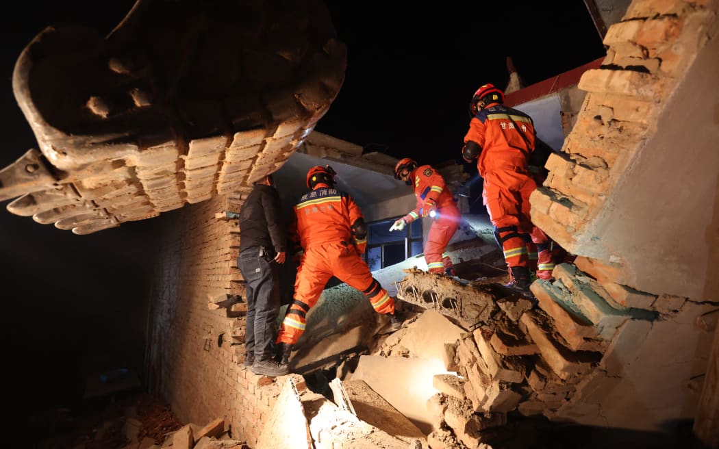 Rescue workers search a house for survivors after an earthquake in Kangdiao village, Dahejia, Jishishan County, in northwest China’s Gansu province on December 19, 2023. At least 111 people were killed when an earthquake collapsed buildings in northwest China, state media reported on December 19, as rescue workers raced to start digging through rubble. (Photo by AFP) / China OUT