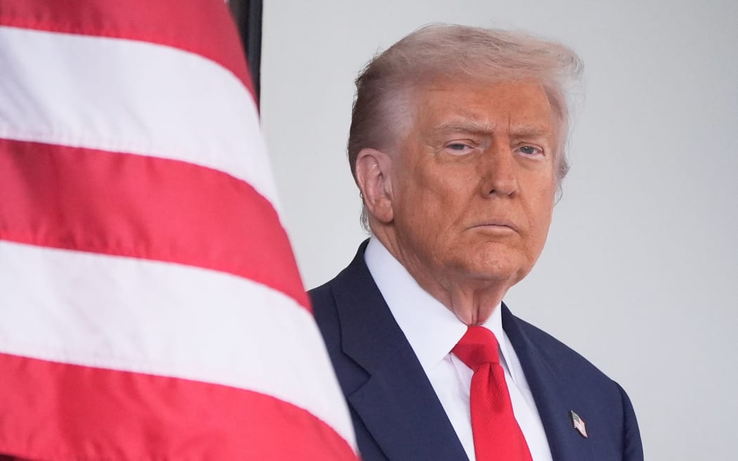 President Donald Trump waits to greet Argentina's President Javier Milei, as he arrives at the White House on 14 October 2025 in Washington.