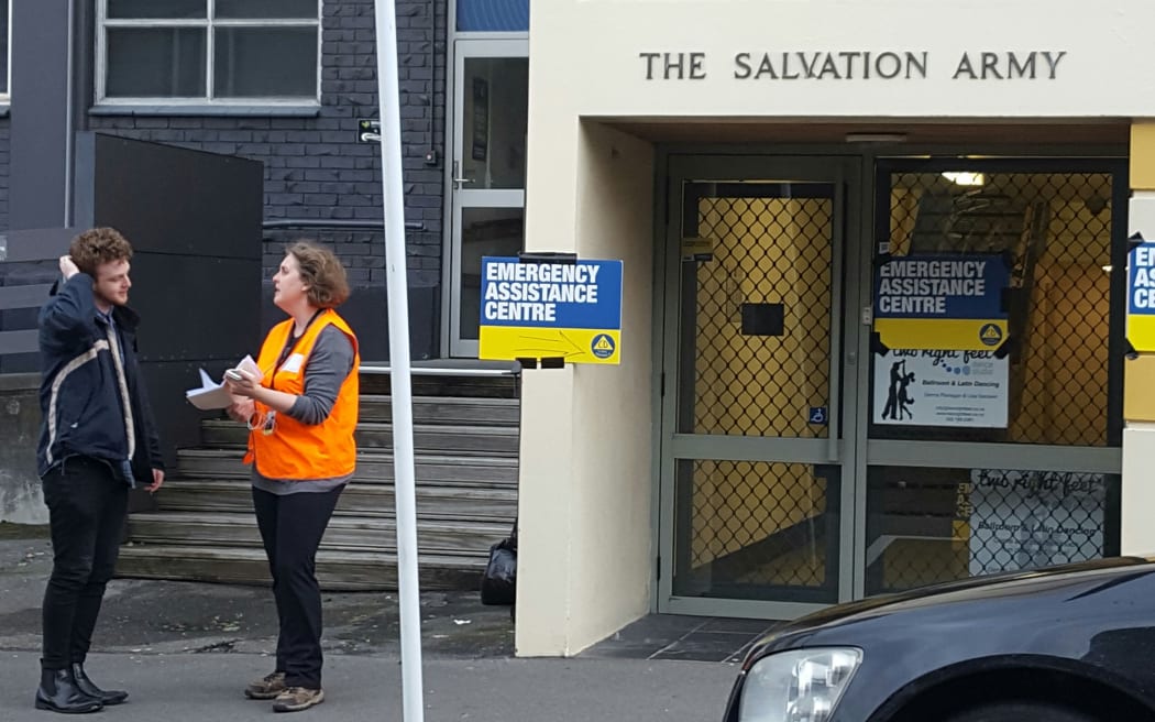 Central Wellington resident Toby Jones talks to a Civil Defence official outside the evacuation centre.
