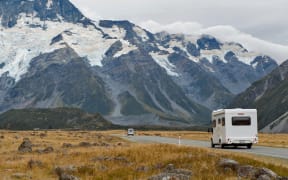 Motorhome on Mount Cook Road (State Highway 80) along the Tasman River leading to Aoraki / Mount Cook National Park and the village