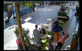 A screengrab of a video shows a woman knocked to the ground on Federal Street in central Auckland on Sunday 5 May 2024.