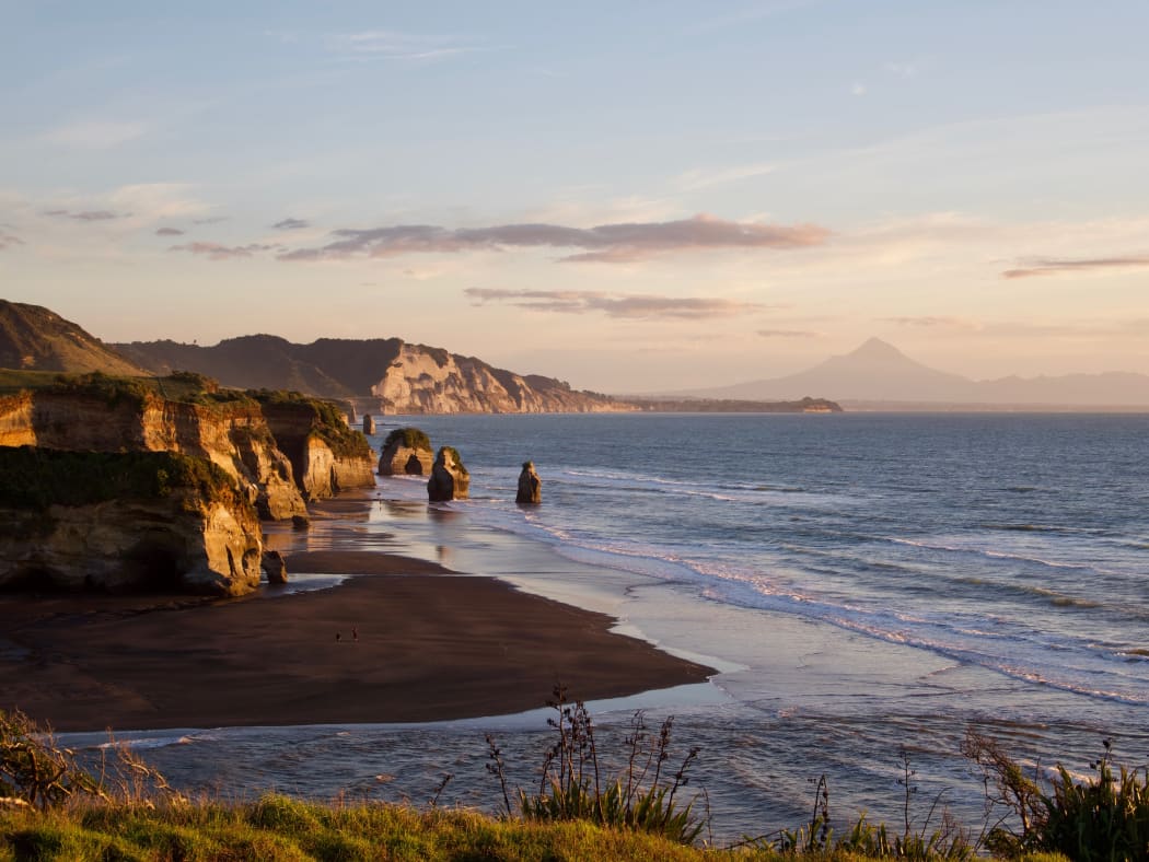 The Three Sisters with Taranaki's coastlines and Mt Taranaki in the background.