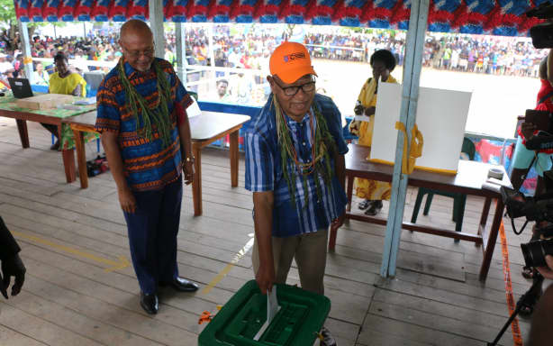 Bougainville's independence referendum in November 2019 - the Autonomous PNG Region's president at the time, John Momis, casts his vote, watched on by PNG's Minister for Bougainville Affairs, Puka Temu.