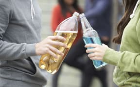 teenage group drinking alcohol together