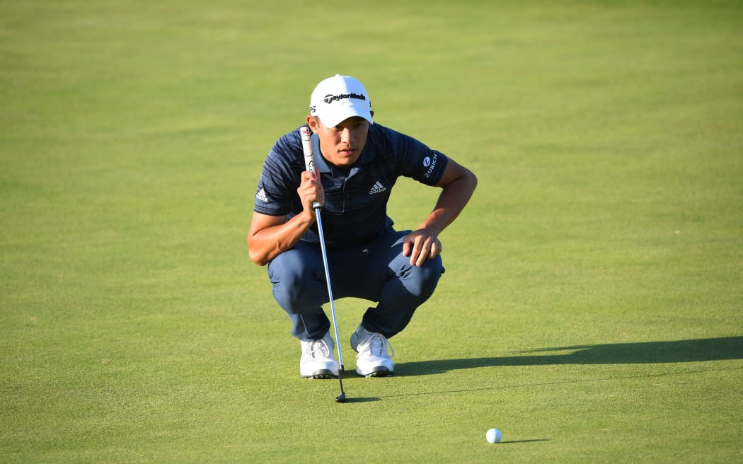 US golfer Collin Morikawa lines up a putt on the 16th green during his third round of The 149th British Open Golf Championship at Royal St George's, Sandwich in south-east England on July 17, 2021.