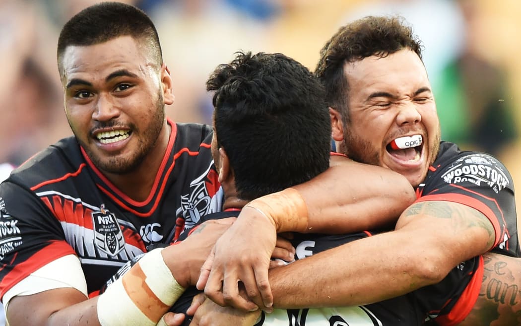 Issac Luke celebrates his try with Sam Lisone and Jazz Tevaga.