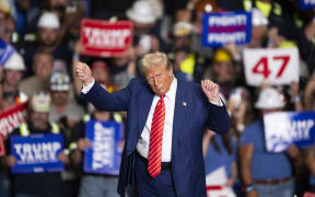 Former US President and Republican presidential candidate Donald Trump dances to a song as he leaves a rally at 1st Summit Arena at the Cambria County War Memorial in Johnstown, Pennsylvania, on August 30, 2024.