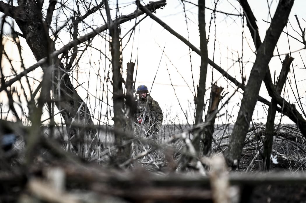 A serviceman from the 65th Separate Mechanized Brigade of the Land Forces of the Armed Forces of Ukraine is standing on the outskirts of Robotyne in the Zaporizhzhia region, southeastern Ukraine, on February 21, 2024. (Photo by Ukrinform/NurPhoto) (Photo by Dmytro Smolienko / NurPhoto / NurPhoto via AFP)
