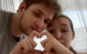 Yuriy Ackermann and his wife Alice - they sent this photo to their friends who are hiding in the underground car park to remind them that "we are with them, together in all of this"