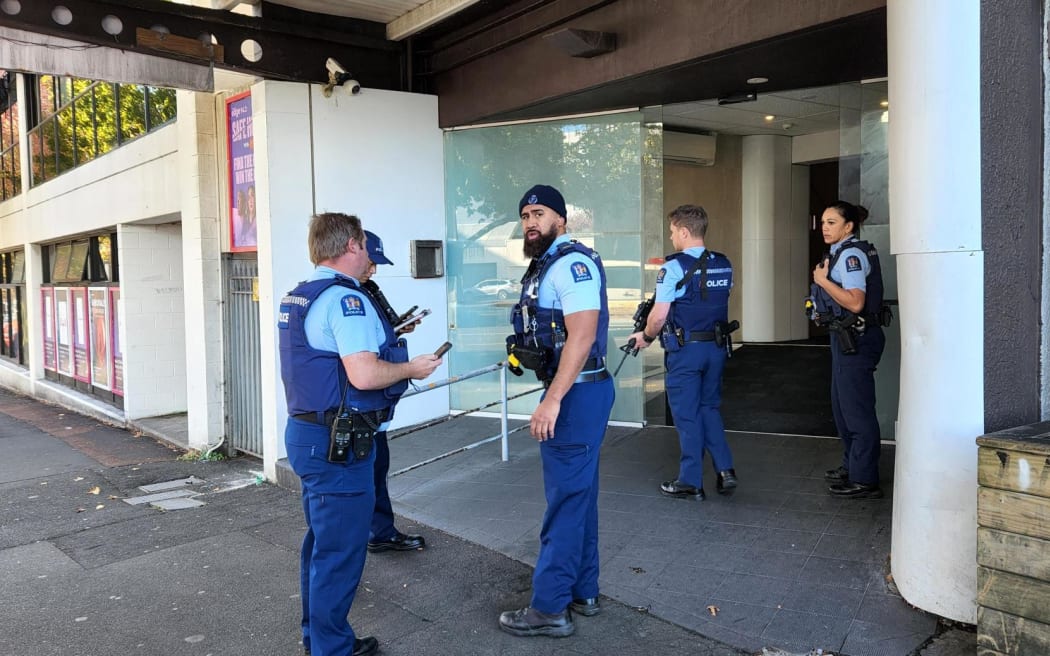 Armed police outside Goodview Apartment Hotel on Hobson Street in central Auckland.
