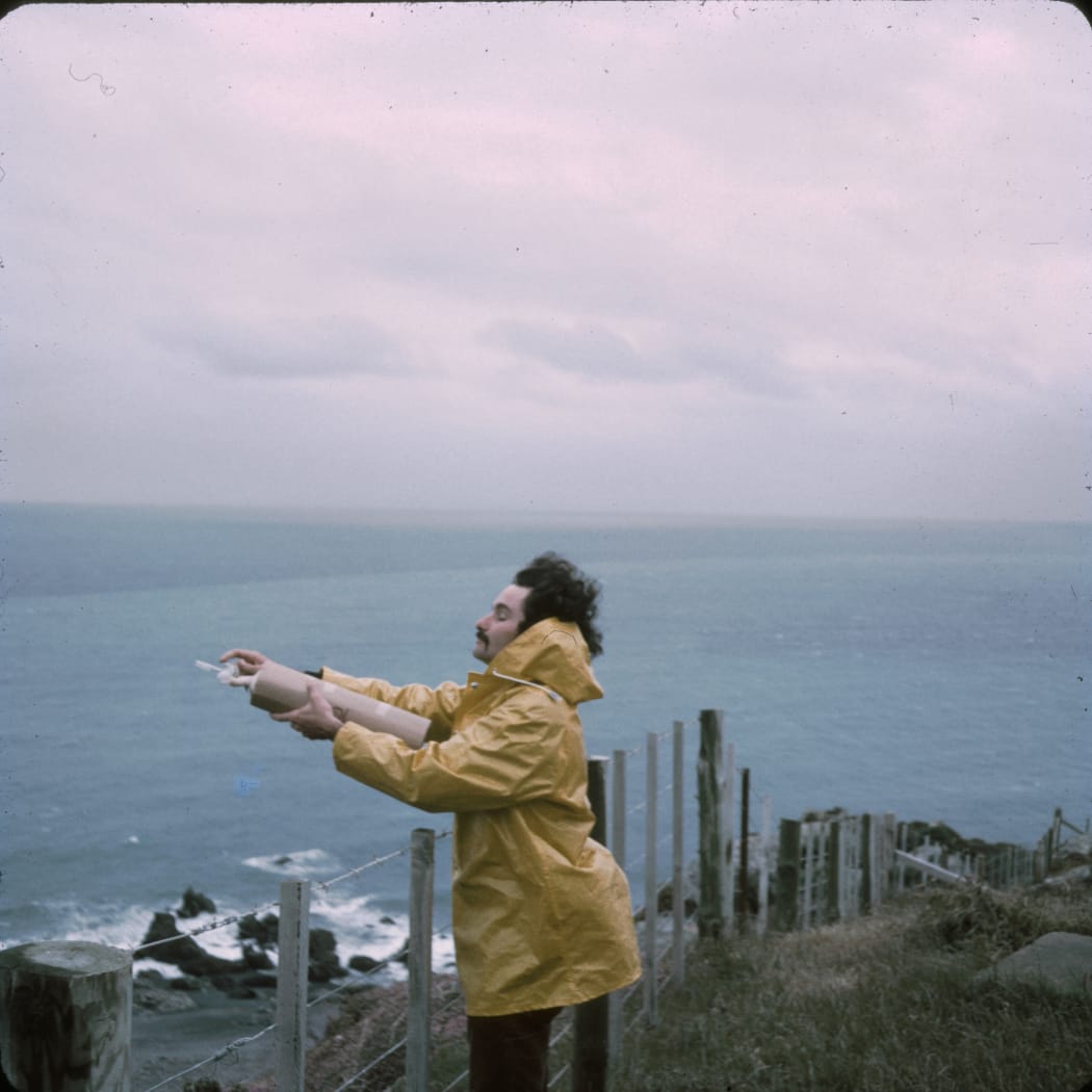 Dave Lowe taking an air flask sample at the edge of the Baring Head cliff in 1972.