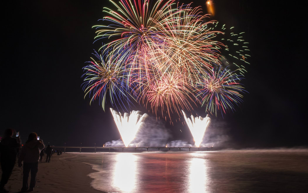 Fireworks illuminate the sky above the New Brighton Pier during Christchurch's first-ever Matariki fireworks spectacular in Christchurch, New Zealand on July 10, 2021. The Matariki is an annual new year celebration of the Maori's, the indigenous people of New Zealand. (Photo by Sanka Vidanagama/NurPhoto) (Photo by SANKA VIDANAGAMA / NurPhoto via AFP)