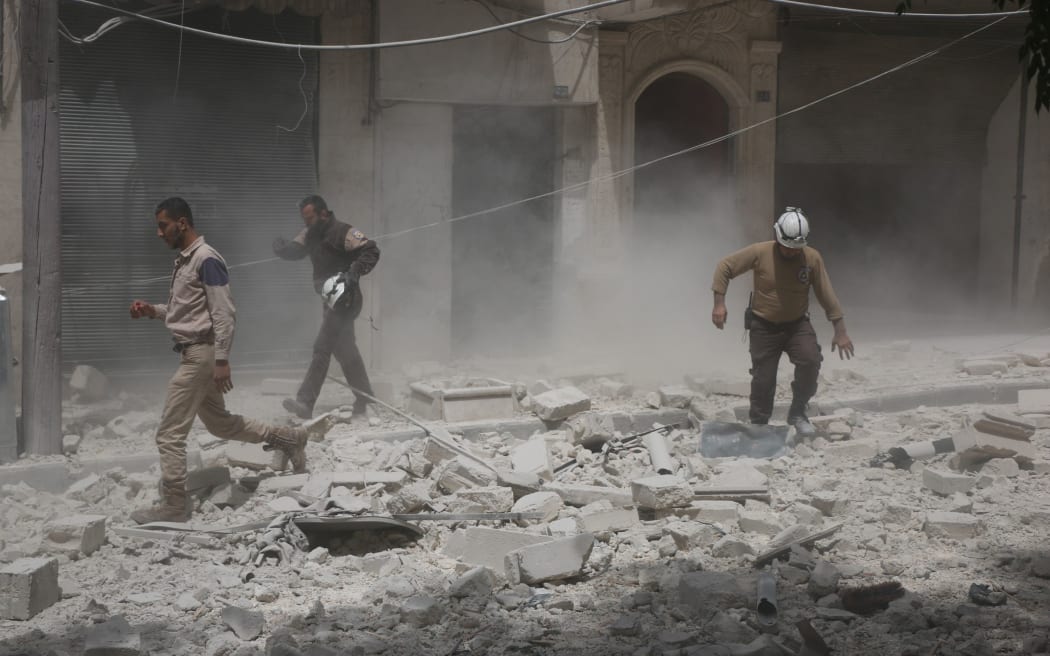 People inspect rubble of houses after Syrian Regime Forces airstrikes targeted residential areas at Sahur neighborhood in Aleppo, Syria on April 24.