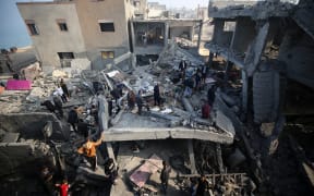 Palestinians are inspecting the damage in the rubble of a building destroyed during Israeli bombardment in Deir Balah in the central Gaza Strip, on December 2, 2023, amid continuing battles between Israel and the militant group Hamas. Israel is carrying out deadly bombardments in Gaza for a second day on December 2 after a week-long truce with Hamas collapsed despite international calls for an extension.