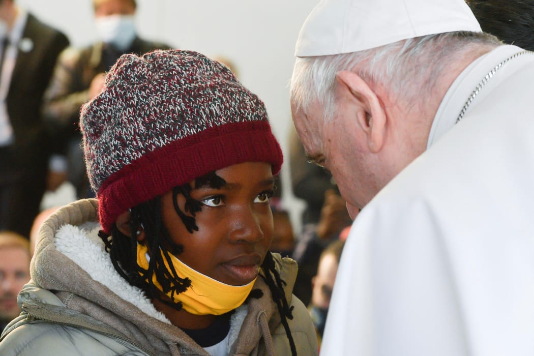 Pope Francis meets a young asylum -seeker at a camp on the Greek island of Lesbos.