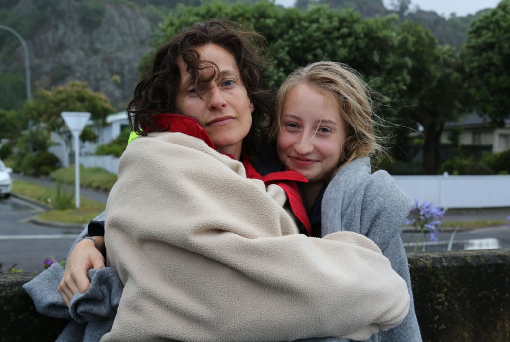 Antje Ruehmkorf, left, and her daughter Rieke from Germany, back on land after their rescue from the PeeJay V which caught fire burning while returning from a tour to White Island.